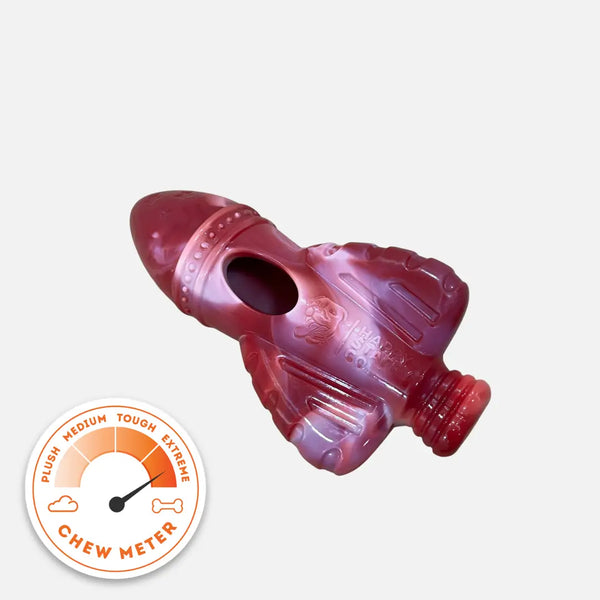 Red rocket-shaped dog chew toy from the Chewzilla® Galactic Quest Collection shown with a tough-chewer durability meter